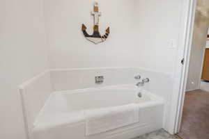 Full bathroom featuring a bath