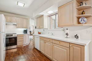 Kitchen featuring open shelves, light brown cabinetry, light countertops, and white appliances