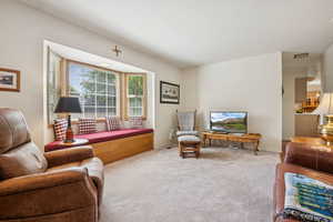 Carpeted living room featuring baseboards