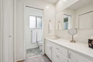 Bathroom featuring vanity and a shower