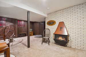 Interior space featuring carpet and a lit fireplace