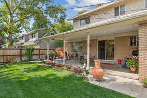 Rear view of house featuring a patio area and brick siding