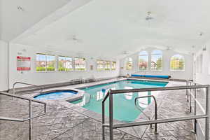 View of pool with a pool with connected hot tub, a sunroom, and ceiling fan