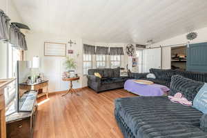 Living area featuring a barn door and light wood-style floors