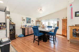 Dining room featuring light wood finished floors and lofted ceiling