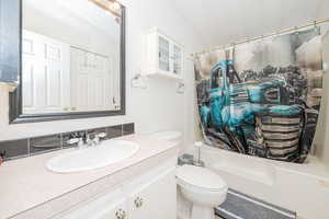 Bathroom with vanity and shower / bath combination with curtain
