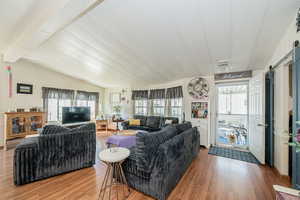 Living room with wood finished floors and a barn door