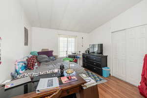 Bedroom with light wood-style flooring and a closet
