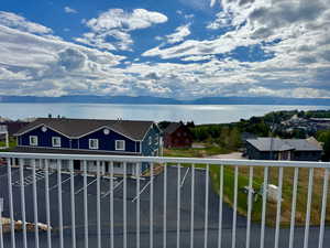 Balcony featuring a water and mountain view
