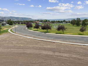 View of asphalt street featuring curbs and a mountain view