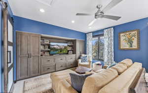 Living area with ceiling fan, recessed lighting, and light carpet
