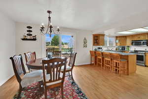 Dining room featuring light wood-style floors and a chandelier
