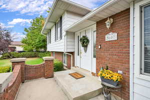 Entrance to property featuring brick siding