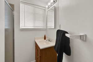 Bathroom featuring vanity and a shower with shower door