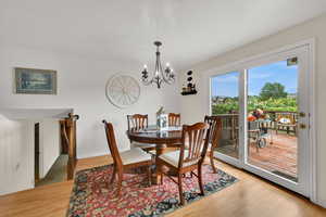 Dining room featuring light wood-style floors and a chandelier