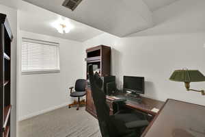 Office featuring a textured ceiling and light carpet
