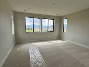 Empty room with carpet and baseboards