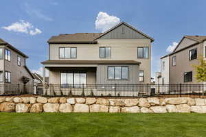 Rear view of house featuring board and batten siding and roof with shingles