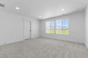 Spare room featuring light carpet, recessed lighting, and a mountain view