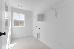 Laundry area featuring hookup for a washing machine, light tile patterned floors, and hookup for an electric dryer