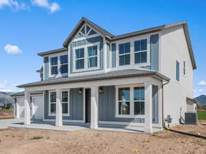 View of front of home with a mountain view, a porch, board and batten siding, and a shingled roof
