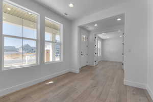 Entrance foyer with recessed lighting, light wood-type flooring, and a residential view