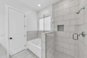 Full bathroom with a shower stall, a garden tub, light tile patterned flooring, and recessed lighting
