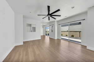 Unfurnished living room featuring light wood-style flooring and a ceiling fan