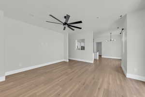 Unfurnished living room featuring light wood-style floors and a ceiling fan