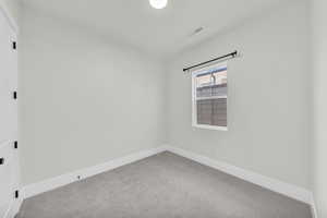 Unfurnished room featuring carpet floors and baseboards