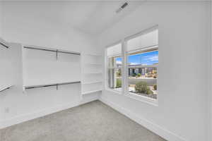 Spare room with light carpet and baseboards