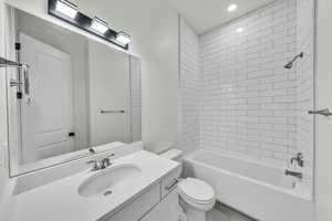Bathroom with  shower combination, vanity, and recessed lighting