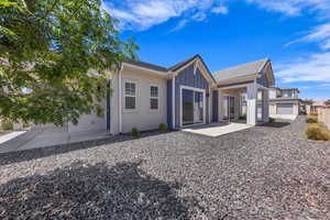 Rear view of property featuring board and batten siding and a patio