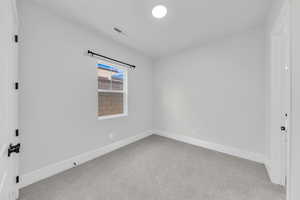 Unfurnished bedroom featuring carpet and baseboards