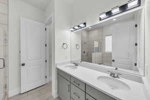 Full bath featuring a shower stall, light tile patterned floors, double vanity, a bath, and recessed lighting