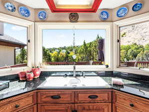 Kitchen with dark stone countertops and brown cabinets