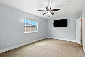 Unfurnished bedroom with light colored carpet and a ceiling fan