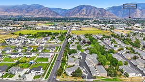 Aerial overview of property's location with nearby suburban area and mountains