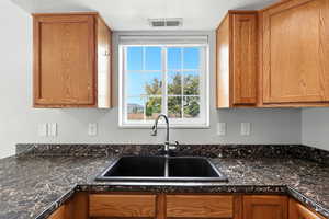 Kitchen featuring brown cabinets and a textured ceiling