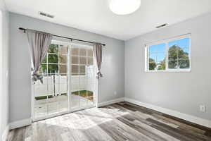 Unfurnished room featuring plenty of natural light and light wood finished floors