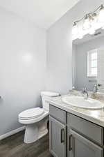 Bathroom featuring vanity and dark wood-style flooring