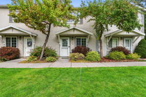 View of front facade featuring stucco siding and a front lawn