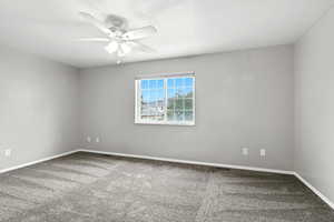 Empty room featuring carpet and a ceiling fan