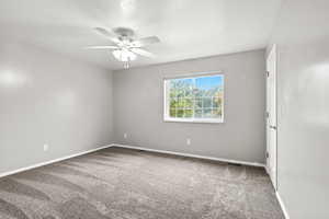 Empty room with light carpet and a ceiling fan