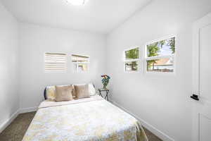 Carpeted bedroom featuring baseboards