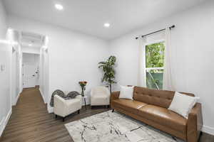Living room featuring dark wood-style floors and recessed lighting