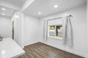 Unfurnished dining area featuring dark wood-style floors and recessed lighting