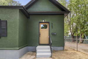 View of exterior entry featuring stucco siding