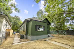 View of property exterior with stucco siding and roof with shingles
