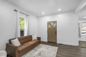 Living room featuring dark wood finished floors and recessed lighting